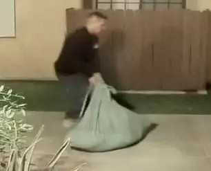 Surveillance Footage Reveals Fugitive Dragging Suspicious Sack Linked to Wife's Murder